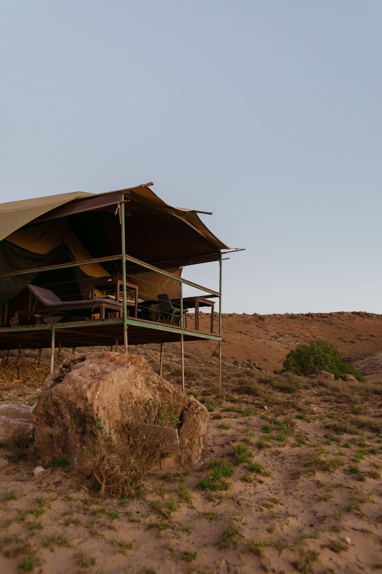 Open savannah at golden hour on an African safari, the landscape the luxury camps are built around